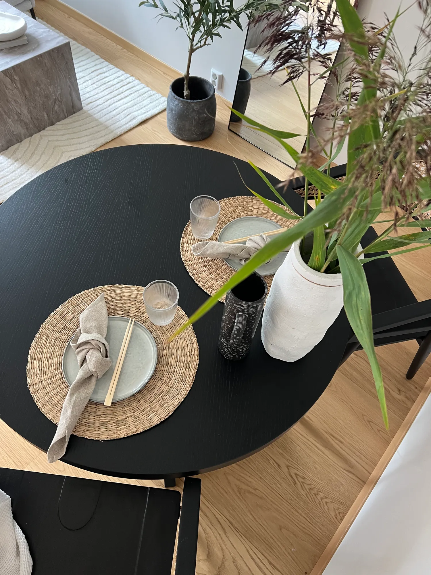 Spisebordet sett ovenfra, med gress i hvit vase
